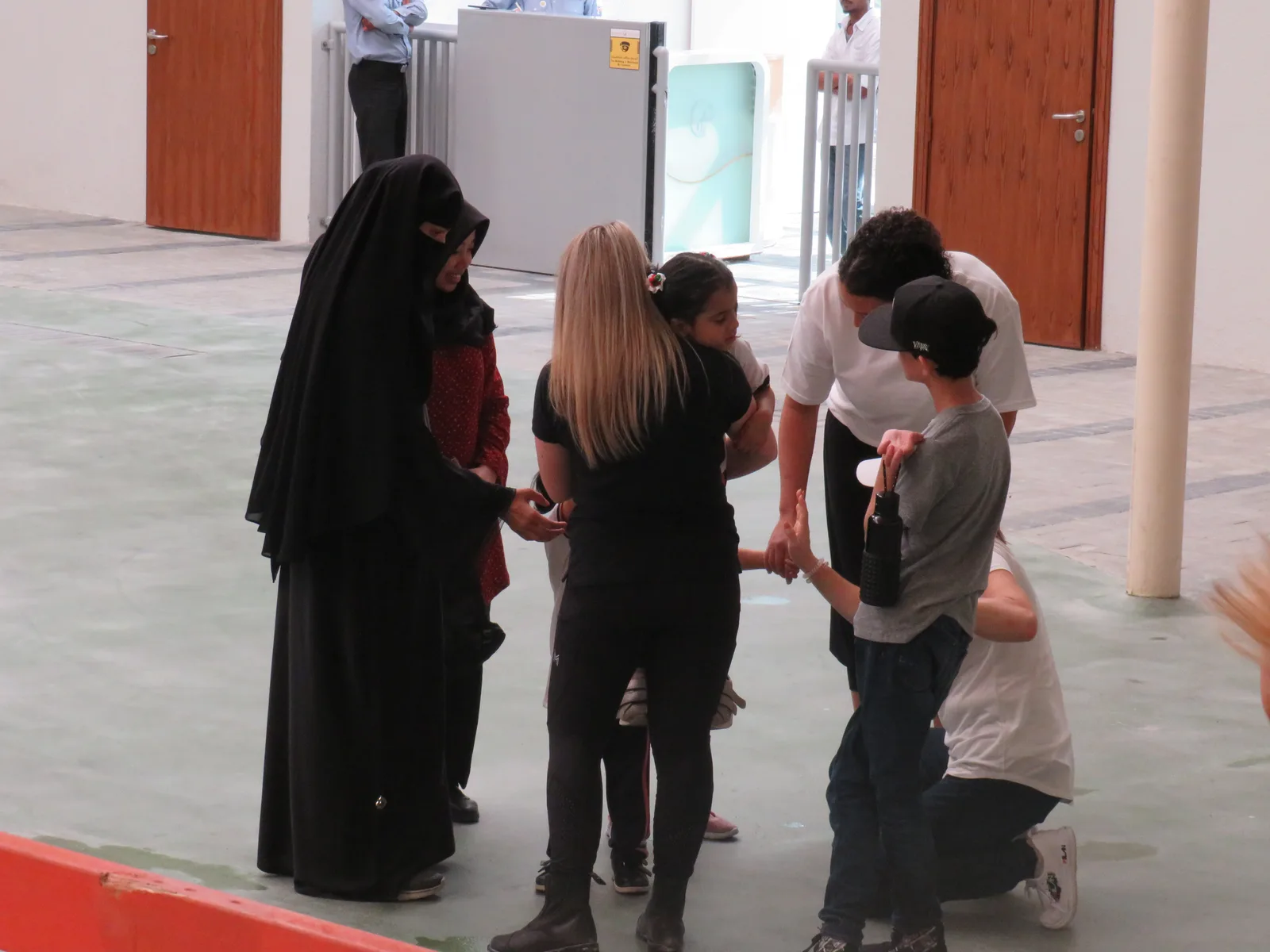 Adults and children talking together during a gathering